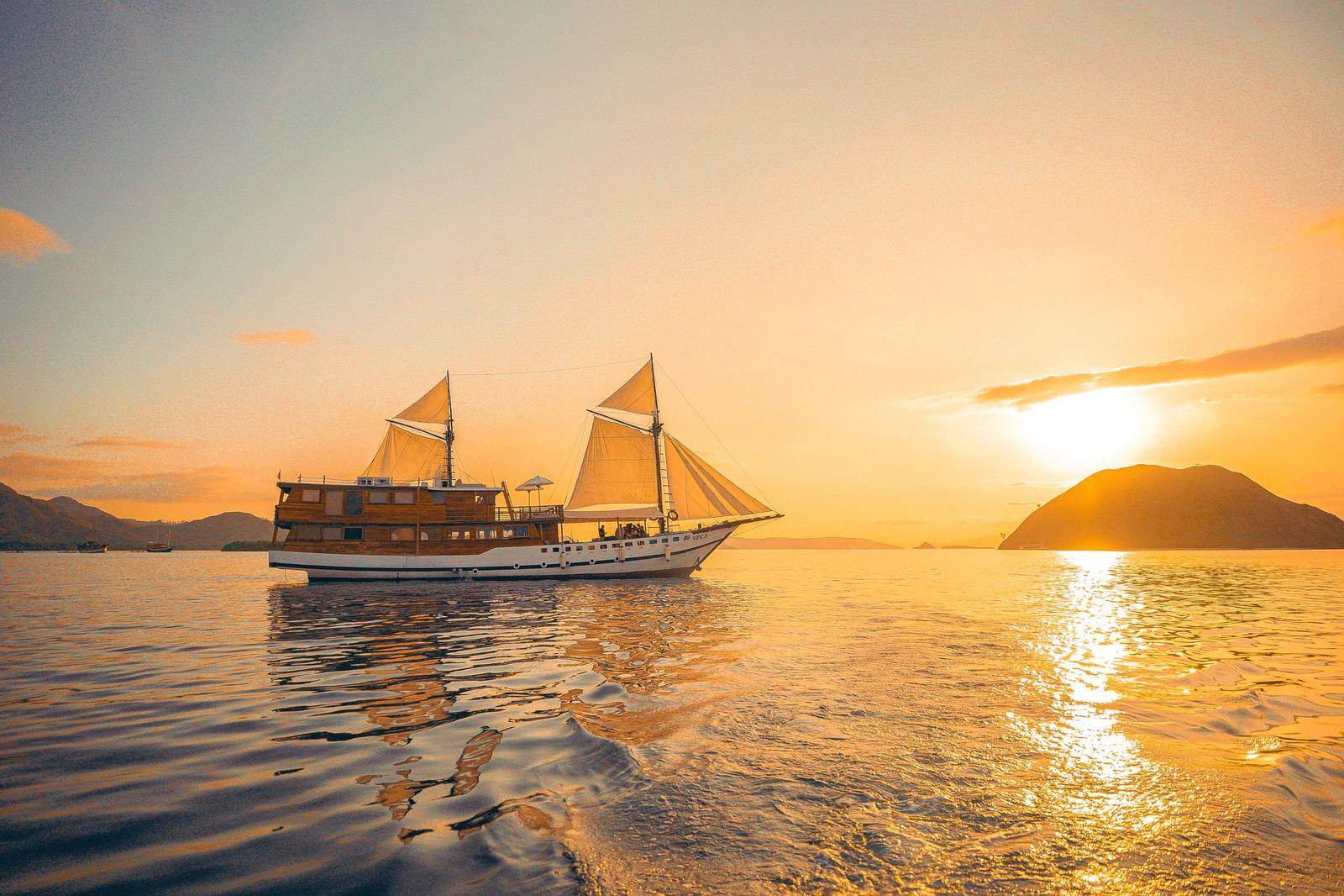 Vinca phinisi under sail at sunset off Komodo